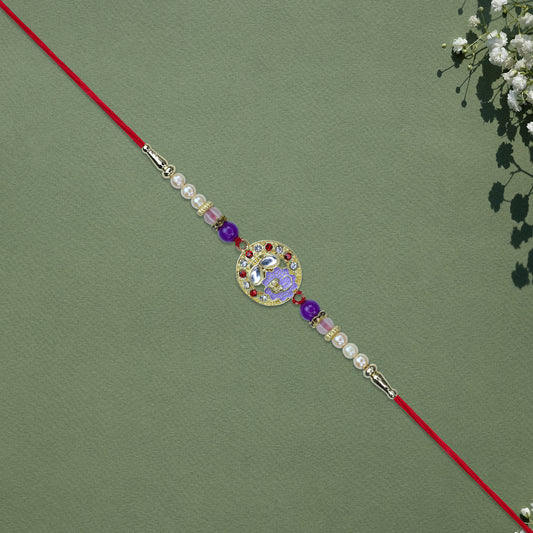 Elegant Ganesh Rakhi With Pearl And Purple Beads