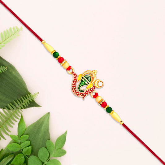 Green Enamel Lord Ganesha Rakhi With Decorative Red Thread And Golden Accents