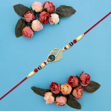 Peacock Feather Design Rakhi With Beaded Detailing And Red Thread