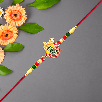 Green Enamel Lord Ganesha Rakhi With Decorative Red Thread And Golden Accents