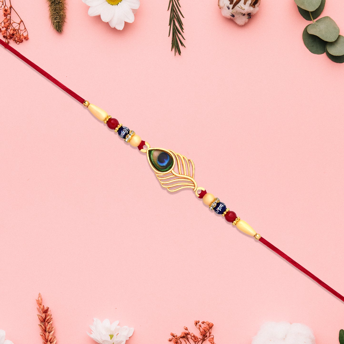 Peacock Feather Design Rakhi With Beaded Detailing And Red Thread